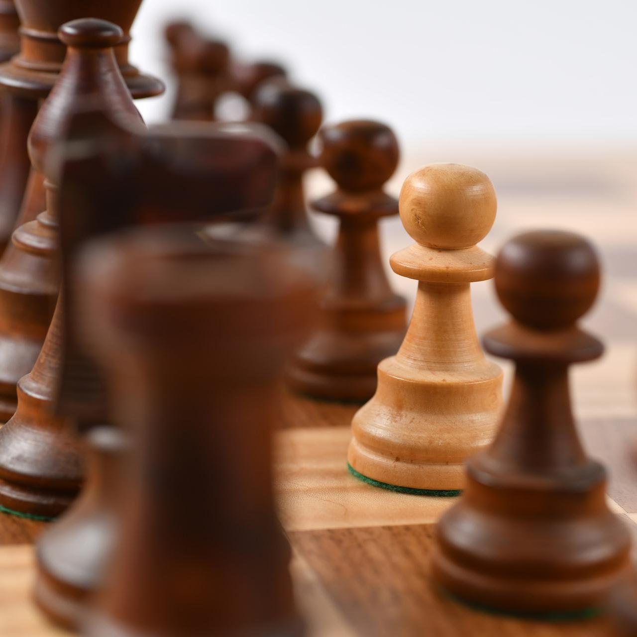 brown wooden chess pieces on chessboard